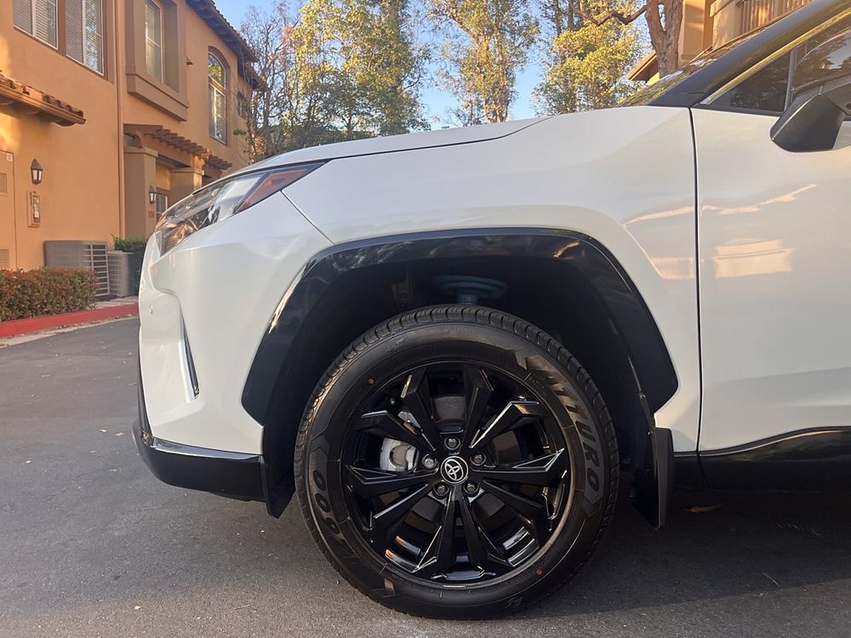 A white RAV4's wheel and tire after a detail